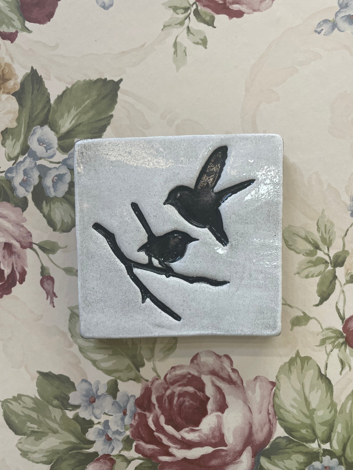 Square tile, white with black birds.