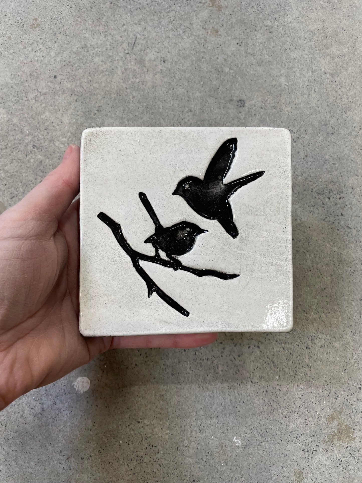 Square tile, white with black birds.