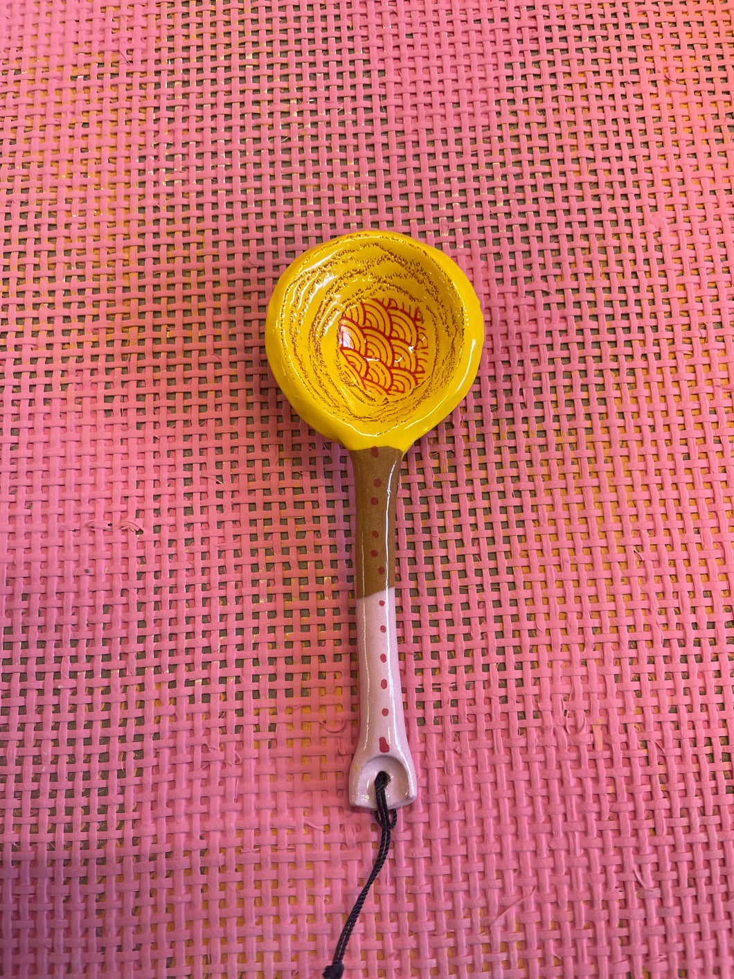 Decorative spoon pink and yellow.