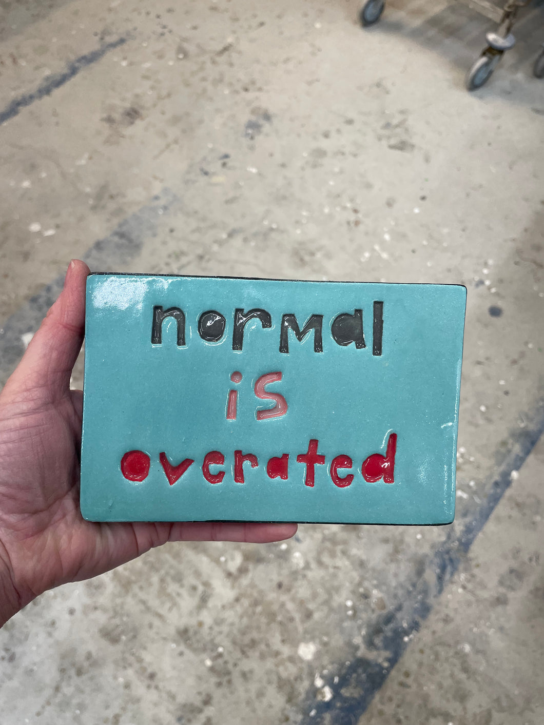 Normal is overrated tile.