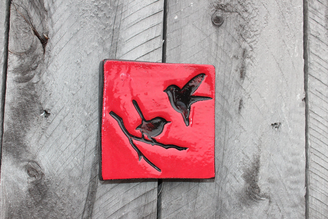 Square tile, red with black birds.